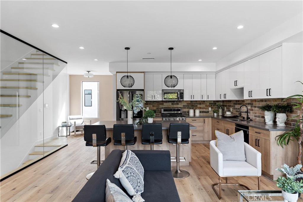 a living room with lots of furniture and kitchen view