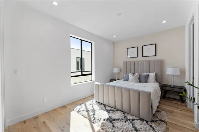 a bedroom with a bed and wooden floor