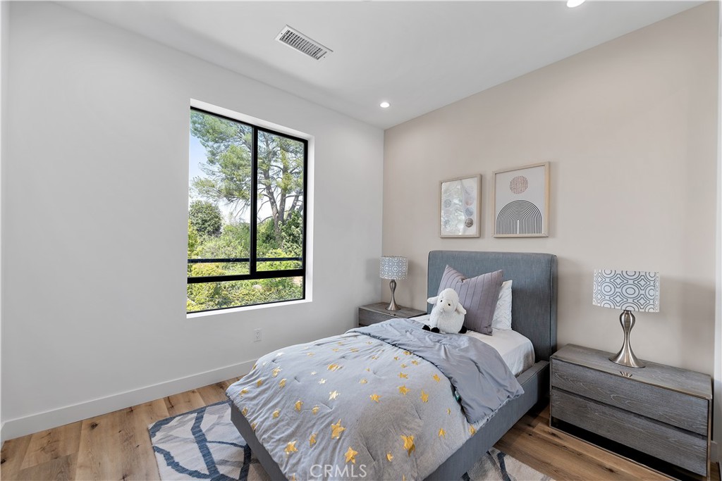 11857 West Flower Ln Valley Village Valley Village, CA 91607 - Photo 30 of 54 a bedroom with a bed and a window