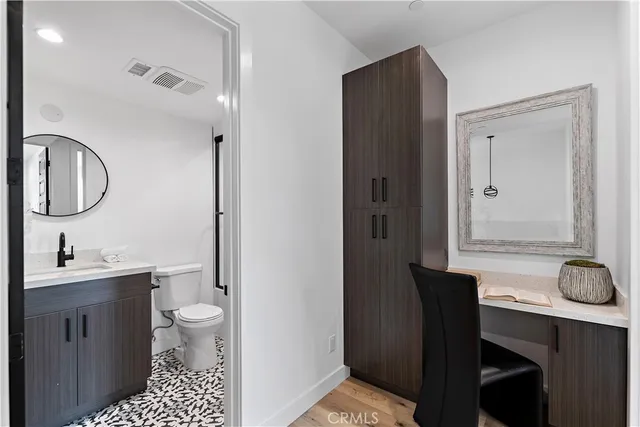 a kitchen with kitchen island granite countertop a sink a stove and cabinets