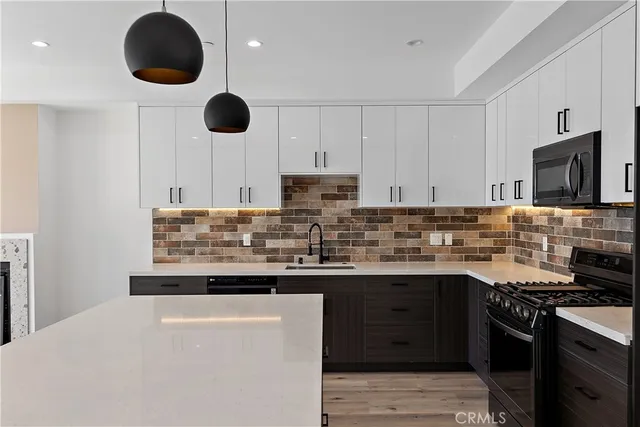 a large kitchen with a large counter top appliances and cabinets