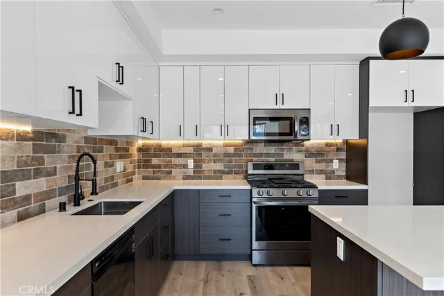 a view of an empty room with a window and fireplace