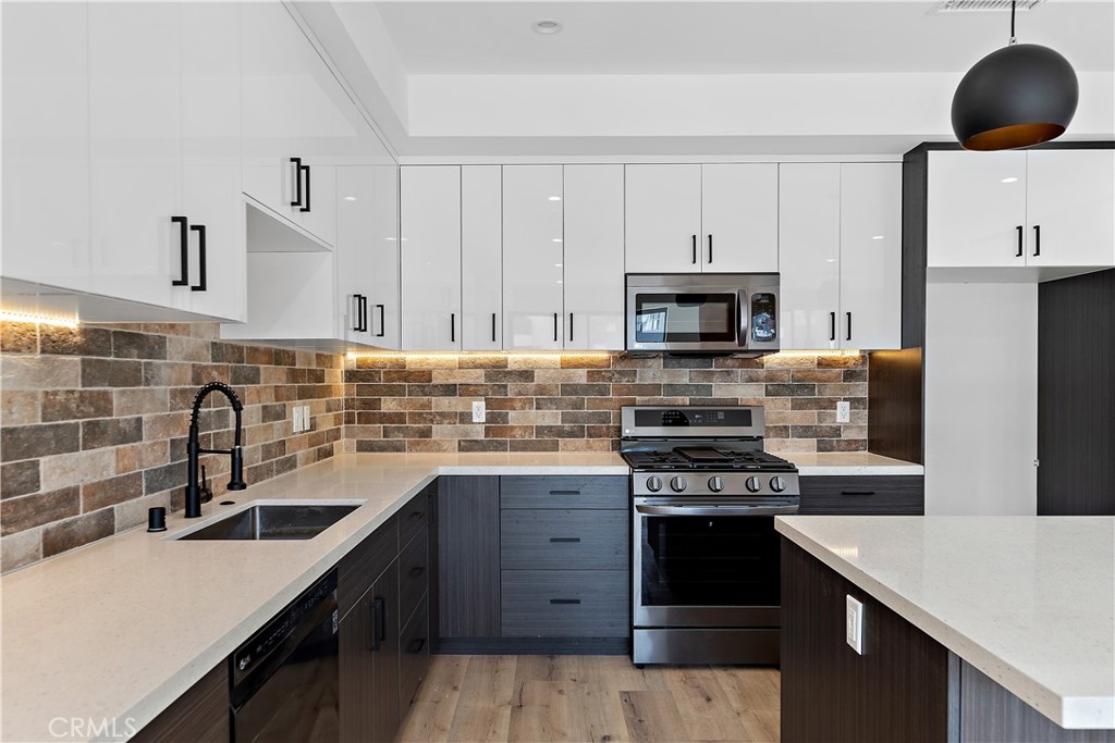11857 West Flower Ln Valley Village Valley Village, CA 91607 - Photo 38 of 54 a kitchen with granite countertop a sink stainless steel appliances and white cabinets