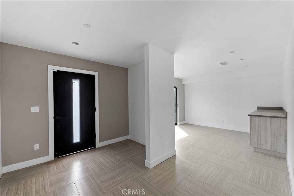 11857 West Flower Ln Valley Village Valley Village, CA 91607 - Photo 50 of 54 an empty room with wooden floor and windows