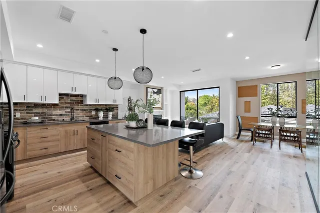 a kitchen with a sink a stove and cabinets