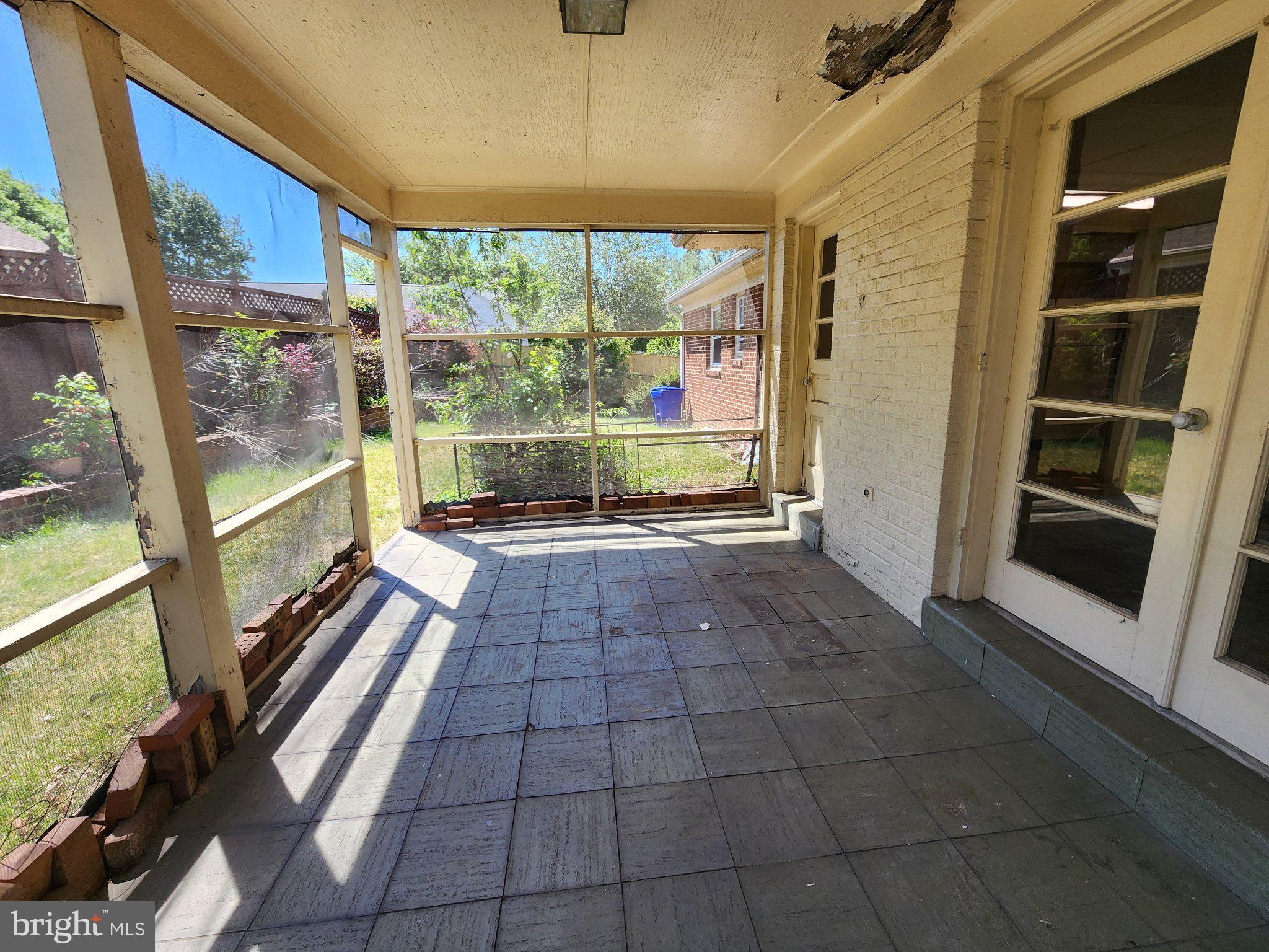 9709 Admiralty Drive Silver Spring, MD 20910 - Photo 37 of 39 Sunlit screened porch with garden views.