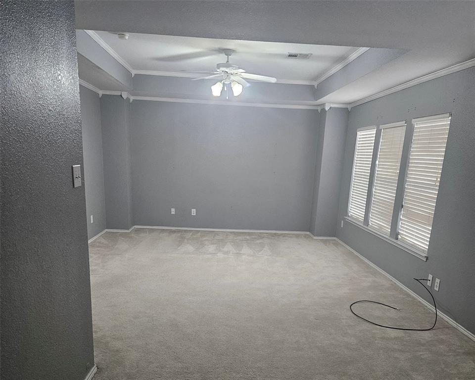 109 Greenfield Trail Forney, TX 75126 - Photo 15 of 26 en empty room with windows and ceiling fan