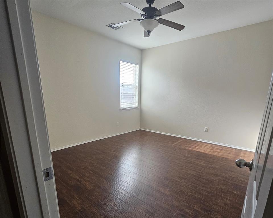 109 Greenfield Trail Forney, TX 75126 - Photo 18 of 26 an empty room with wooden floor fan and windows