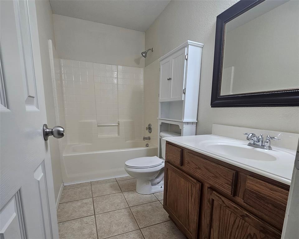 109 Greenfield Trail Forney, TX 75126 - Photo 20 of 26 a bathroom with a sink a toilet a mirror a vanity and shower