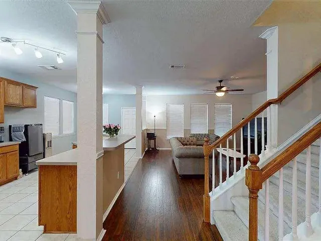 a view of a kitchen with cabinets and wooden floor