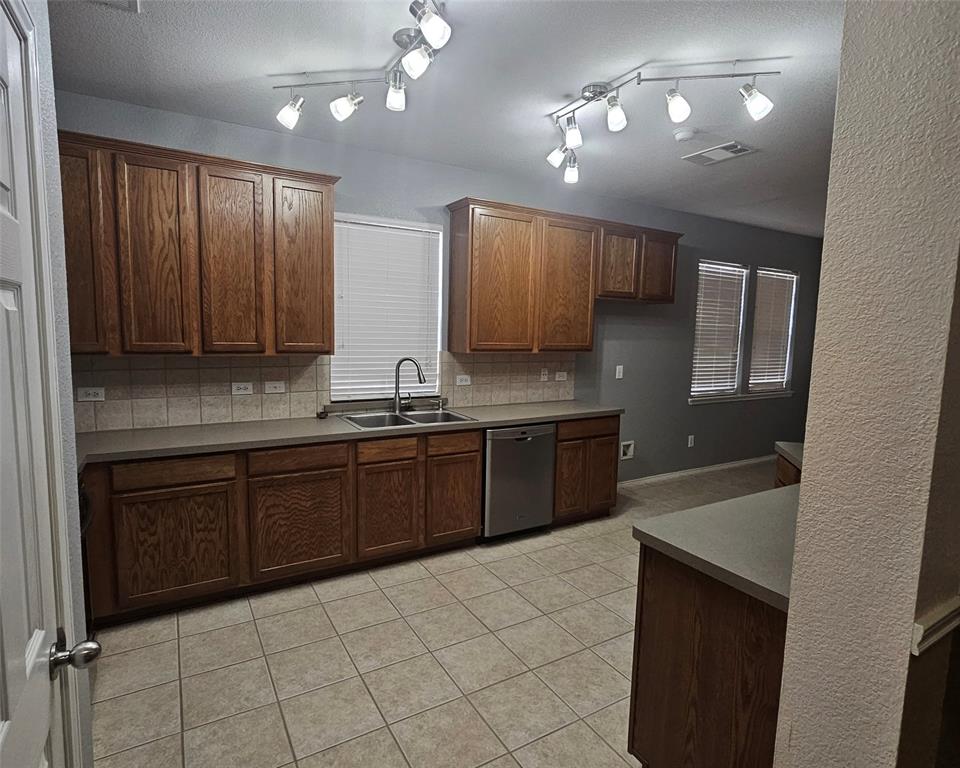 109 Greenfield Trail Forney, TX 75126 - Photo 7 of 26 a large kitchen with granite countertop a sink and cabinets