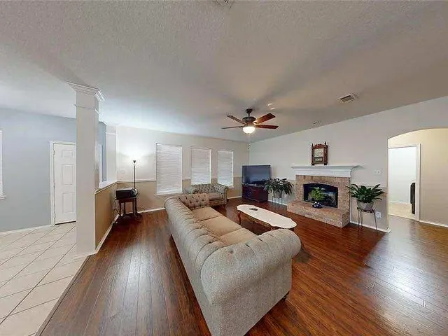 a large living room with furniture and a fireplace