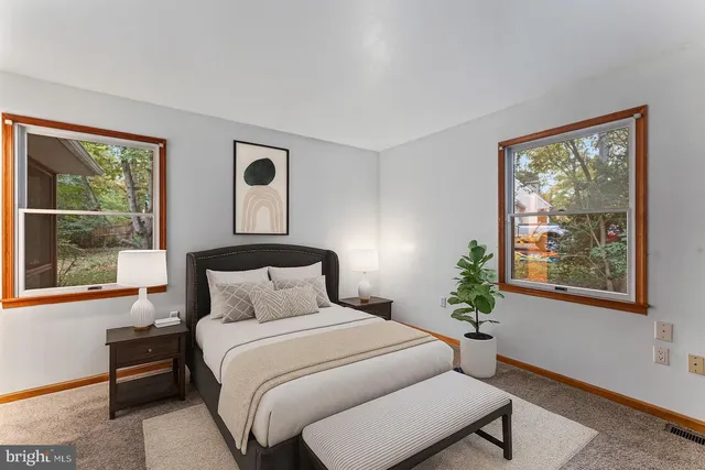 a bedroom with a bed lamp and window