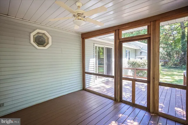 a view of livingroom with furniture and large windows