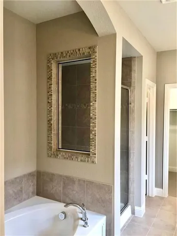 a bathroom with a bathtub and a window