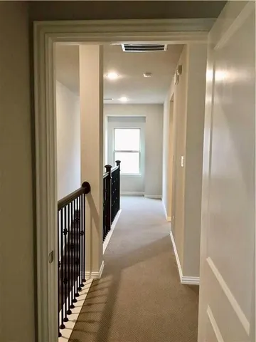 a view of a hallway to a livingroom and a hallway
