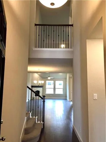a view of staircase with wooden floor and a window