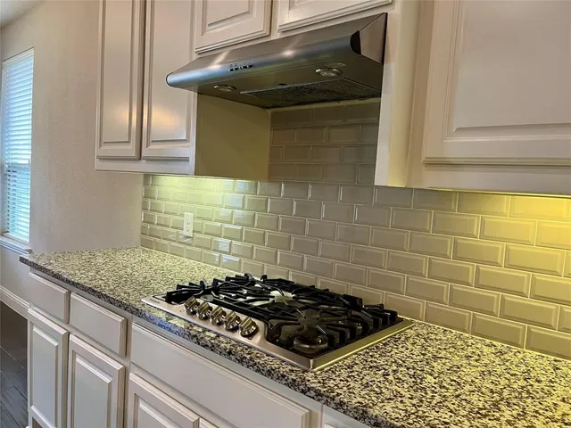 a kitchen with a stove and a cabinets