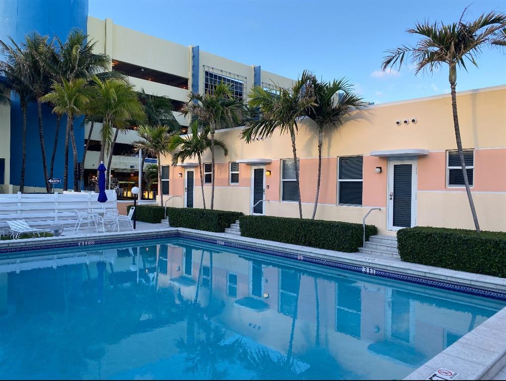 330 Arthur Street, Unit 115 Hollywood, FL 33019 - Photo 14 of 17 a front view of house with yard and swimming pool