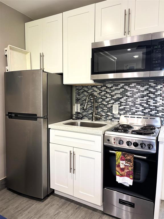 330 Arthur Street, Unit 115 Hollywood, FL 33019 - Photo 3 of 17 a kitchen with stainless steel appliances granite countertop a stove a refrigerator and a microwave