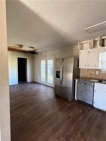 a view of a kitchen with a sink and a refrigerator