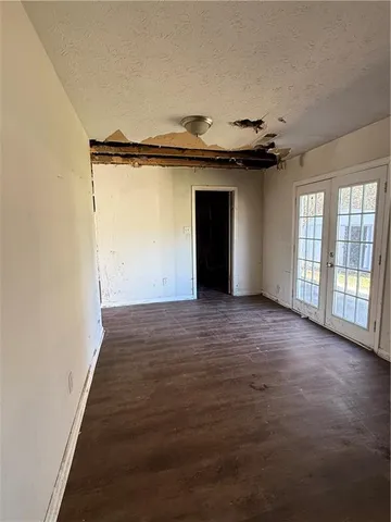 an empty room with wooden floor and a window