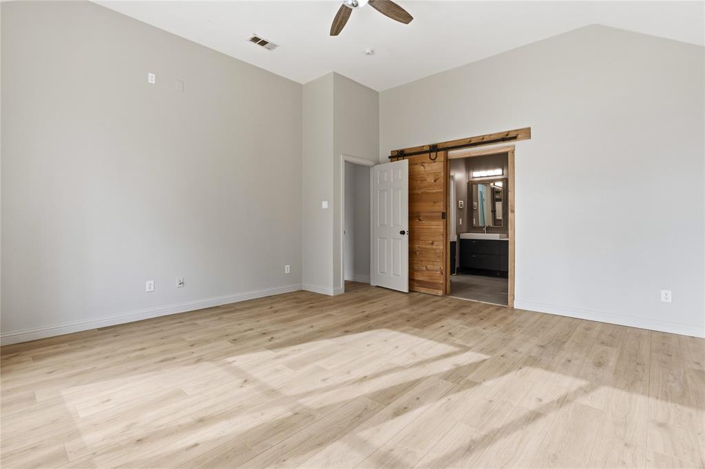 5914 Ambassador Lane Rowlett, TX 75089 - Photo 12 of 40 a view of an empty room with wooden floor and a ceiling fan
