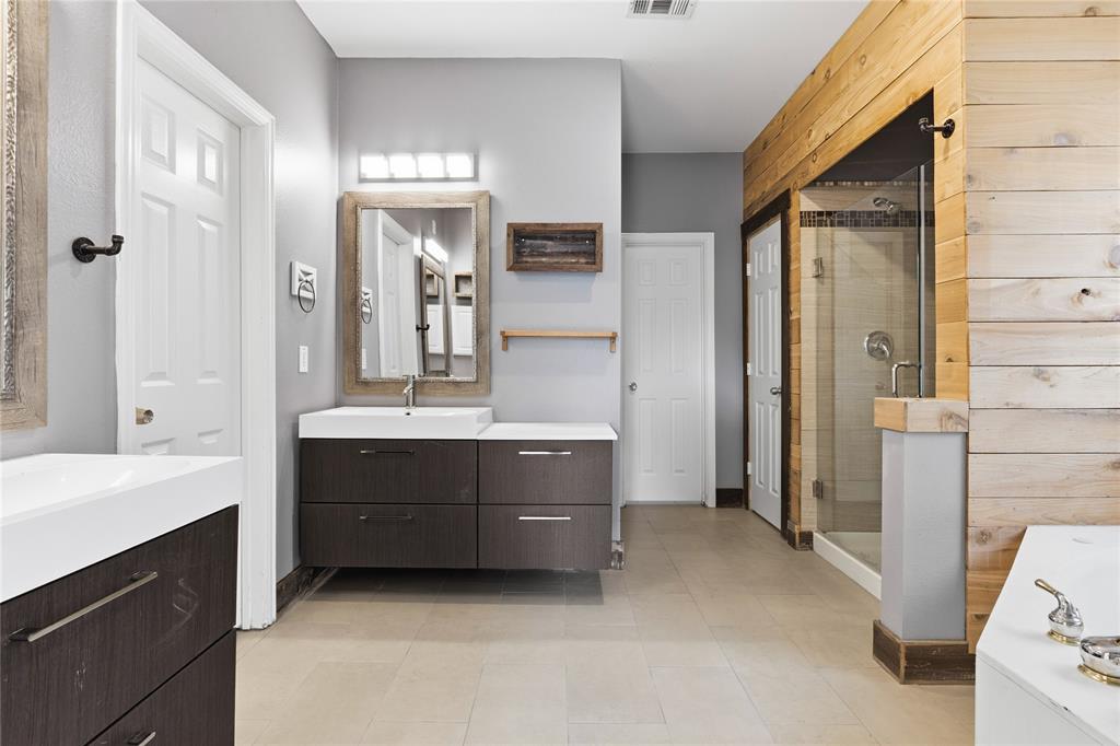 5914 Ambassador Lane Rowlett, TX 75089 - Photo 13 of 40 a bathroom with a double vanity sink and mirror