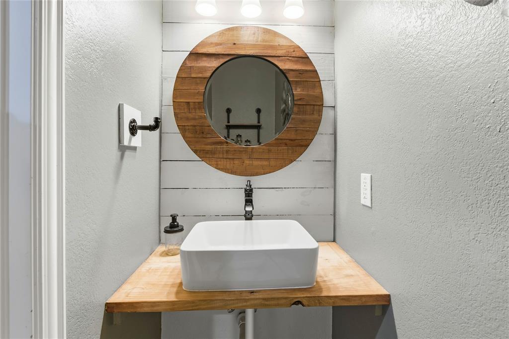 5914 Ambassador Lane Rowlett, TX 75089 - Photo 18 of 40 a bathroom with a sink and mirror