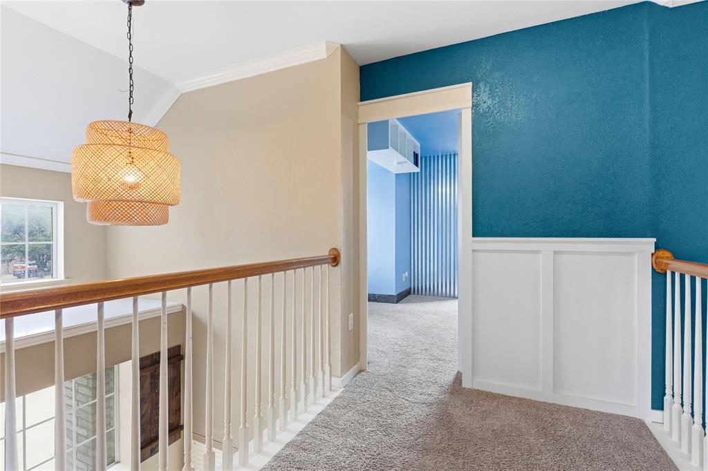 5914 Ambassador Lane Rowlett, TX 75089 - Photo 21 of 40 a view of a hallway with a chandelier