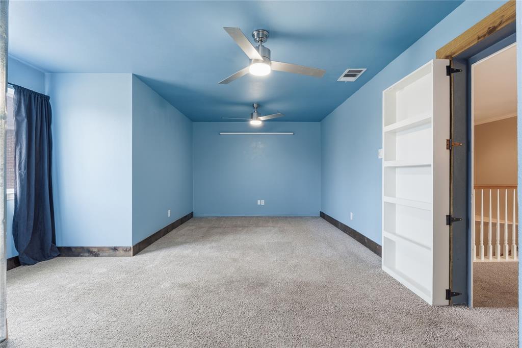 5914 Ambassador Lane Rowlett, TX 75089 - Photo 22 of 40 an empty room with a ceiling fan and a window