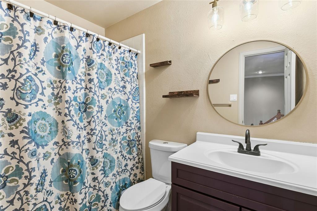 5914 Ambassador Lane Rowlett, TX 75089 - Photo 23 of 40 a bathroom with a sink toilet and mirror