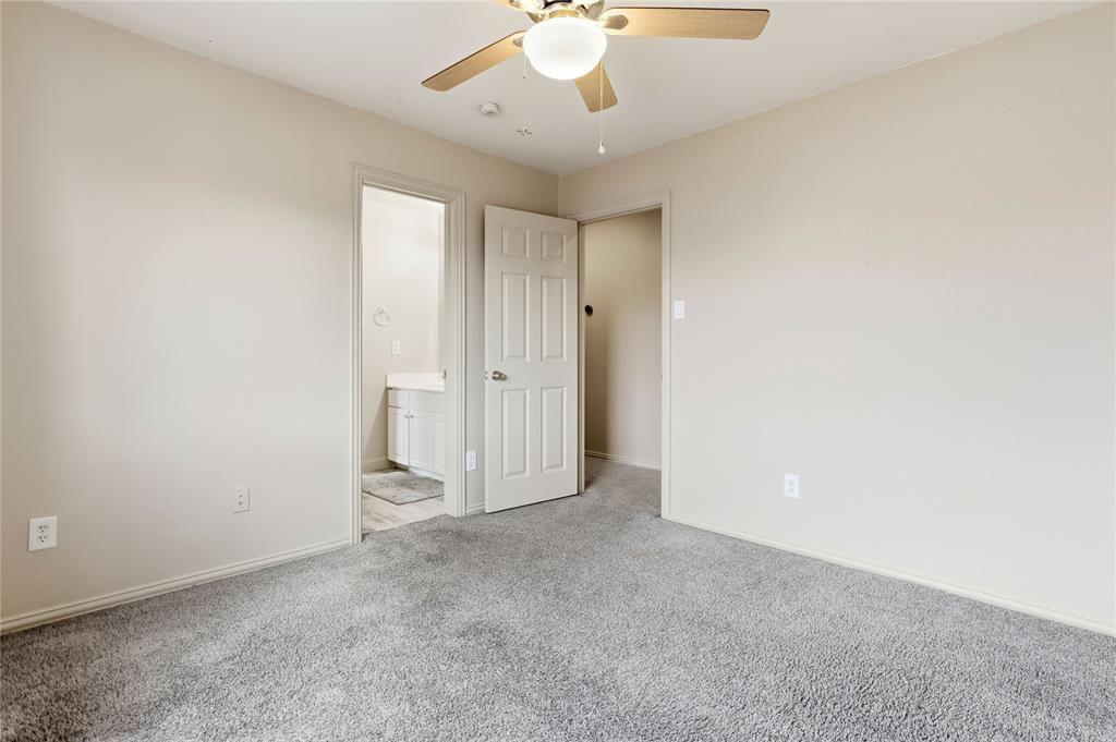 5914 Ambassador Lane Rowlett, TX 75089 - Photo 28 of 40 an empty room with a chandelier fan and windows
