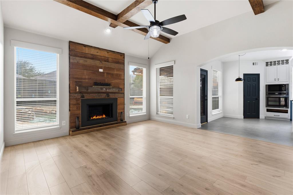 5914 Ambassador Lane Rowlett, TX 75089 - Photo 9 of 40 a view of a livingroom with a fireplace a ceiling fan and window