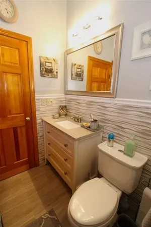 a bathroom with a toilet sink and mirror