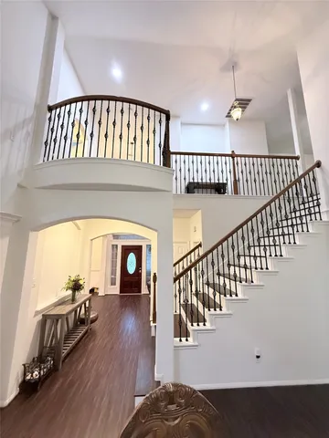 a view of entryway and hall with wooden floor