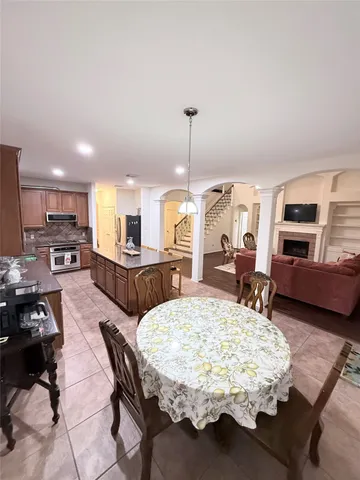 a living room with furniture dining table and a fireplace