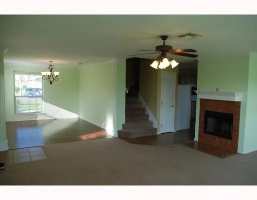 a view of a livingroom with fireplace cabinets and a ceiling fan