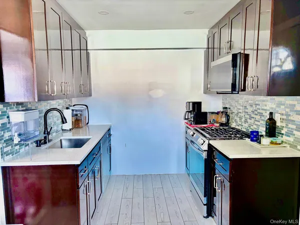 a kitchen with stainless steel appliances a sink stove and refrigerator