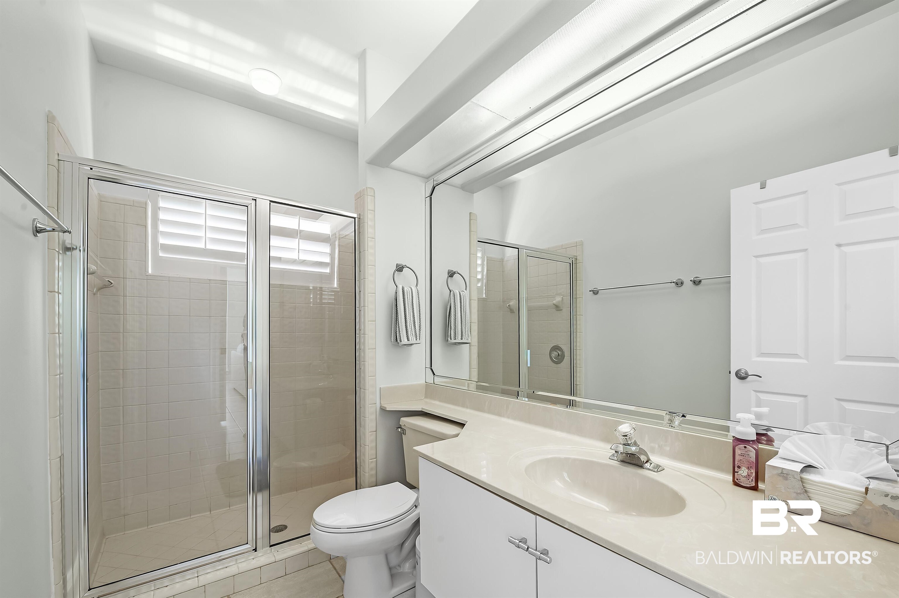 8160 Bay View Drive Foley, AL 36535 - Photo 29 of 43 Full bathroom with a stall shower, toilet, vanity, and tile patterned flooring