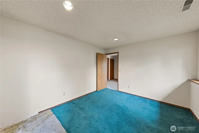 an empty room with a empty space and windows