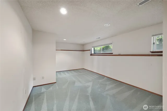 a bathroom with a sink a toilet a mirror and shower