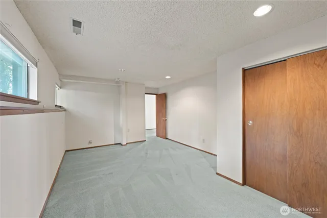 a living room with furniture a fireplace and a large window