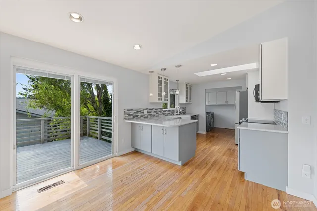 a kitchen with a refrigerator and a stove top oven