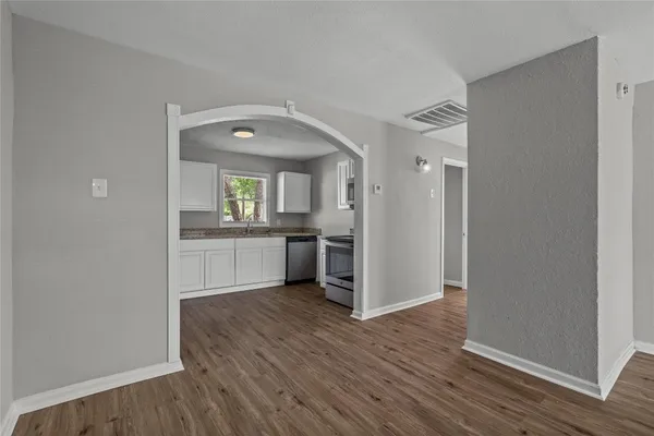 a view of a kitchen cabinets and wooden floor
