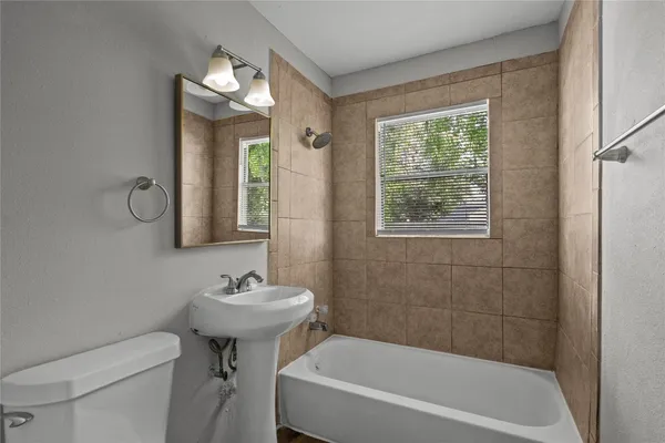 a bathroom with a sink toilet and a bathtub