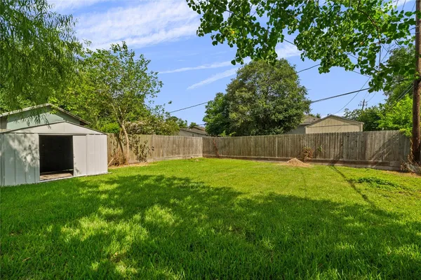 a view of a backyard with a garden and trees