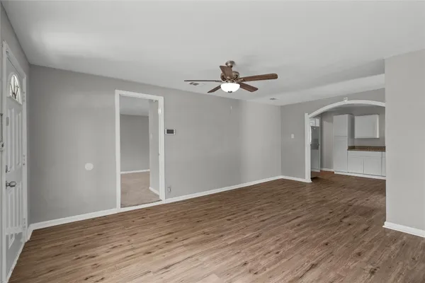 a view of an empty room with wooden floor