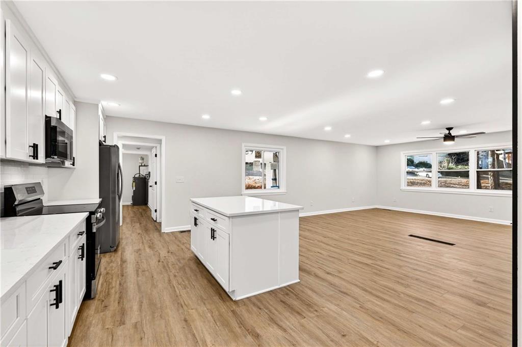 2497 Glenrock Drive Decatur, GA 30032 - Photo 11 of 42 a large kitchen with stainless steel appliances lots of counter top space and wooden floor