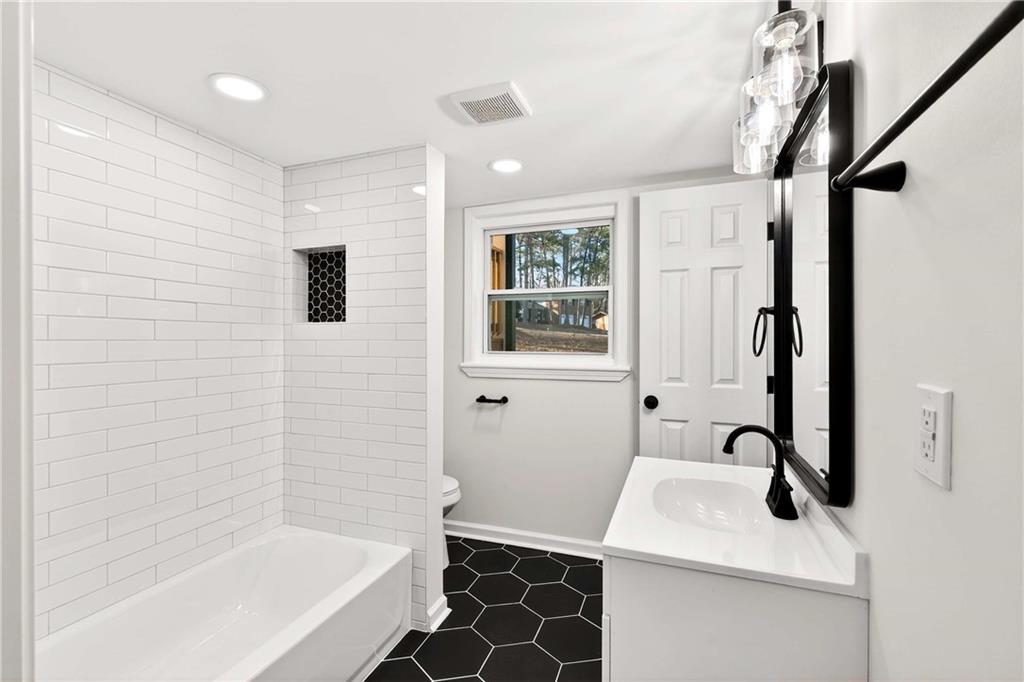 2497 Glenrock Drive Decatur, GA 30032 - Photo 15 of 42 a bathroom with a sink a toilet and shower